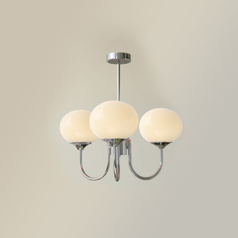 Three beige glass globes on chrome-tone curved arms with a matching rod and canopy