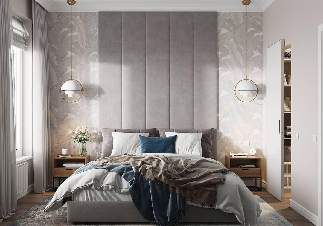 Pair of white circular-frame pendants on either side of a bed.