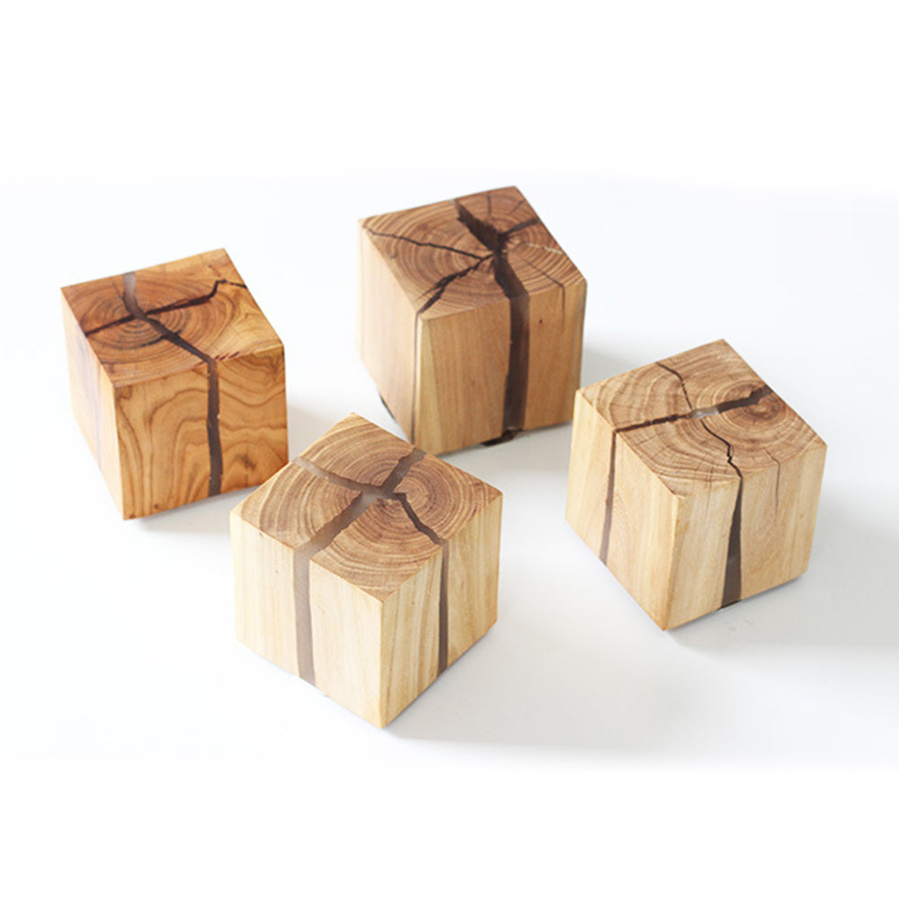 Four wood blocks showing varied grain and crack patterns