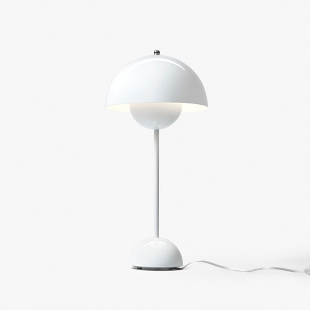 White dome lamp with a pale cable extending from its rounded base on a white background