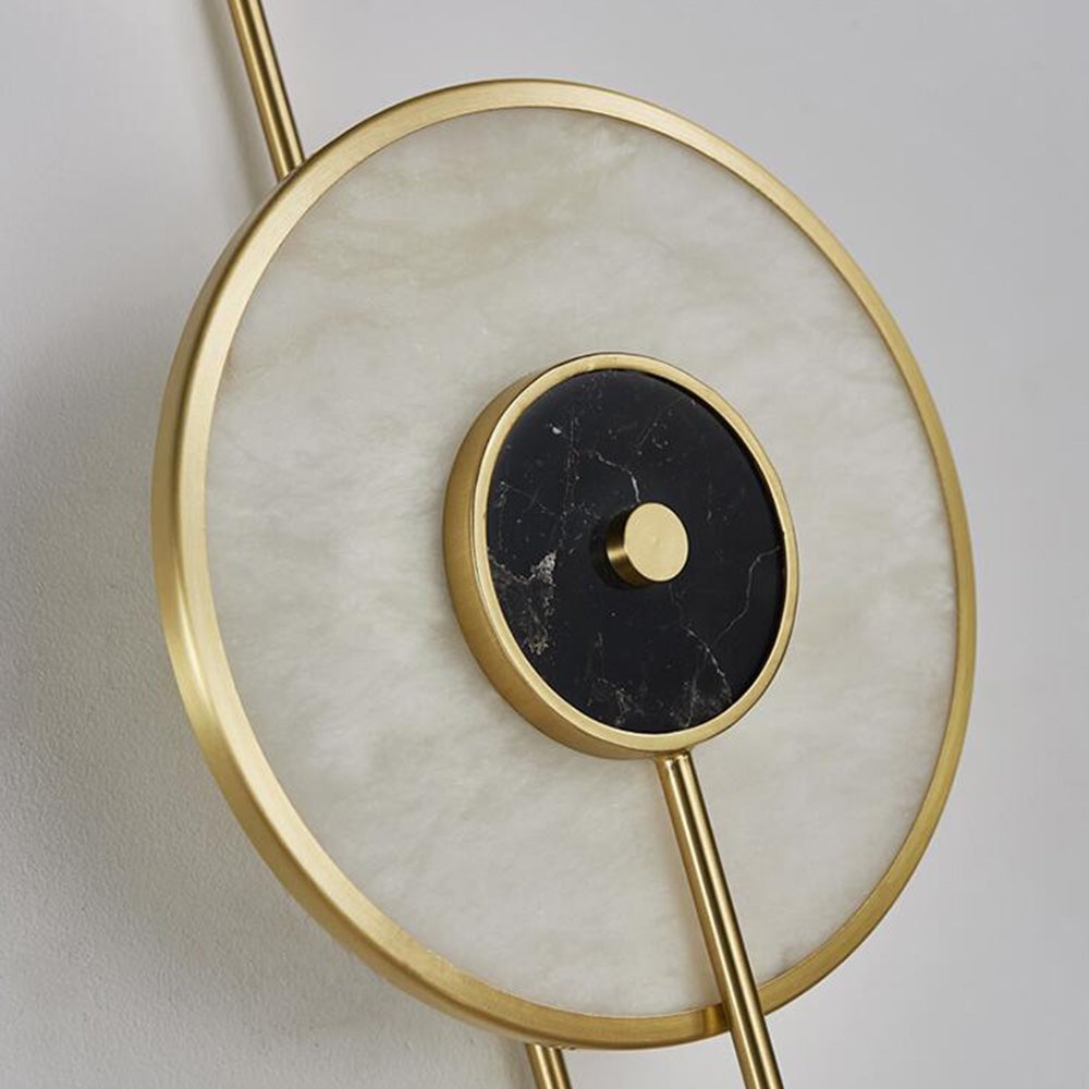 Unlit close-up of pale veined disc and black veined centre with gold-tone rim and central cap