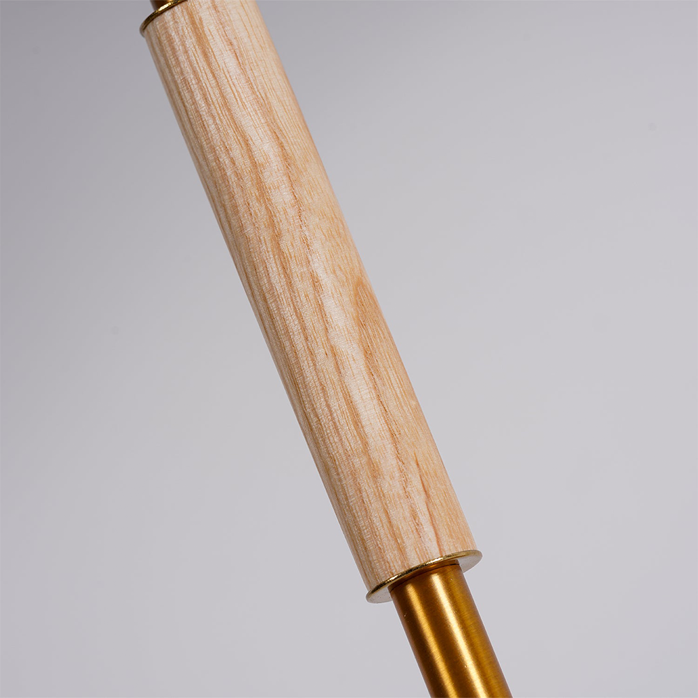 Pale wood-grain sleeve around the gold-tone lamp stem shown in close-up