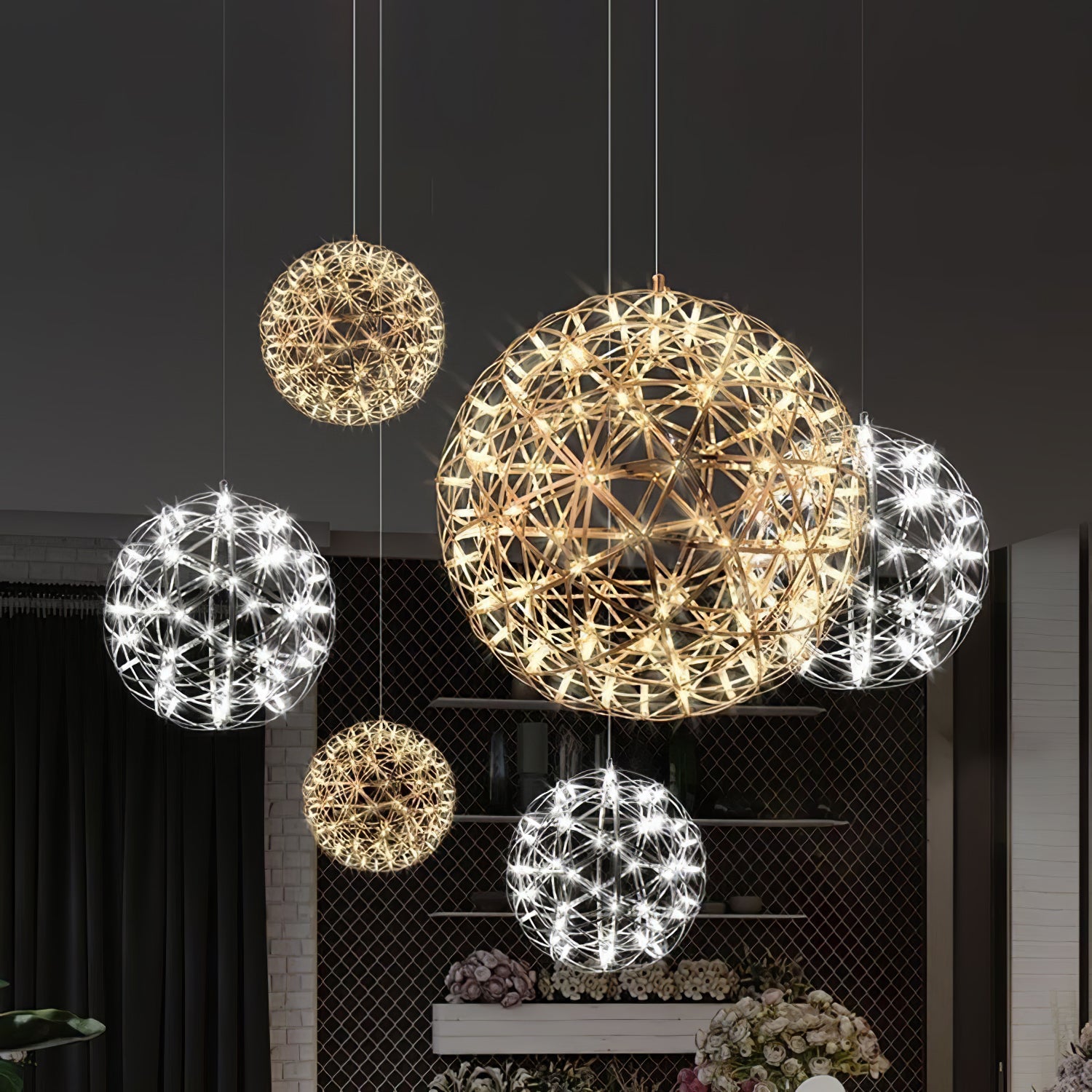 Six glowing lattice globes with warmer and cooler appearances against a pale wall