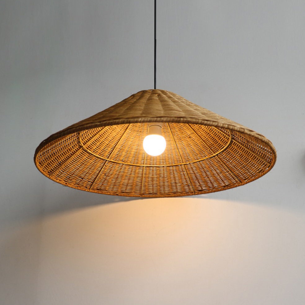 Underside of a lit Brown woven cone shade showing a central bulb, radial ribs and circular support