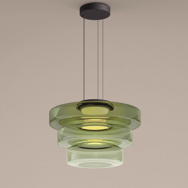 Green three-tier glass pendant with progressively smaller drum shades on a neutral background
