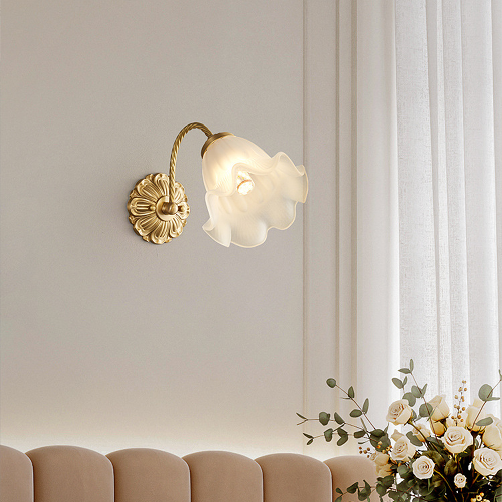 Angled white petal shade and floral plate above scalloped bedhead near sheer curtain and white roses