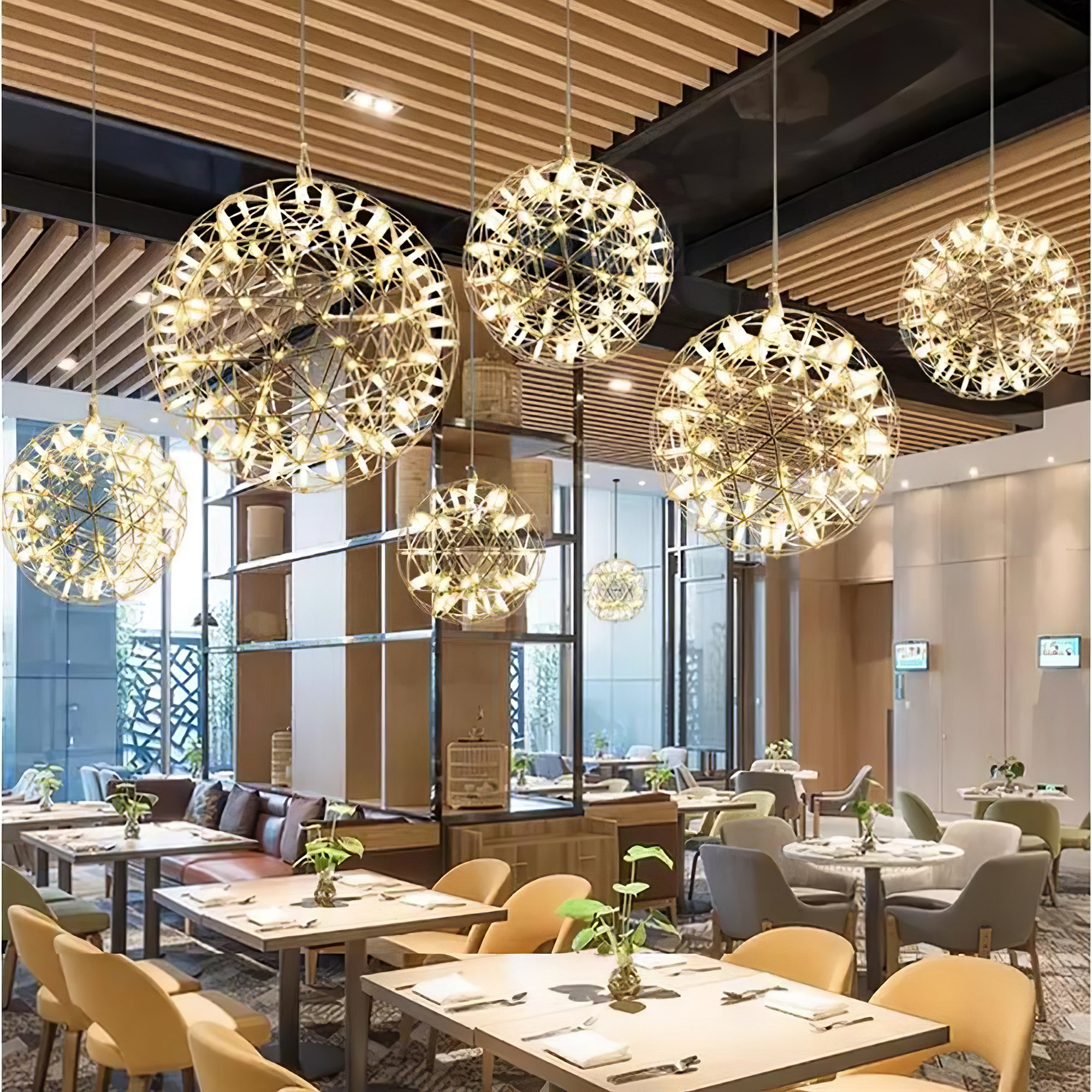 Multiple glowing globe pendants in a wood-lined dining space with yellow chairs and large windows