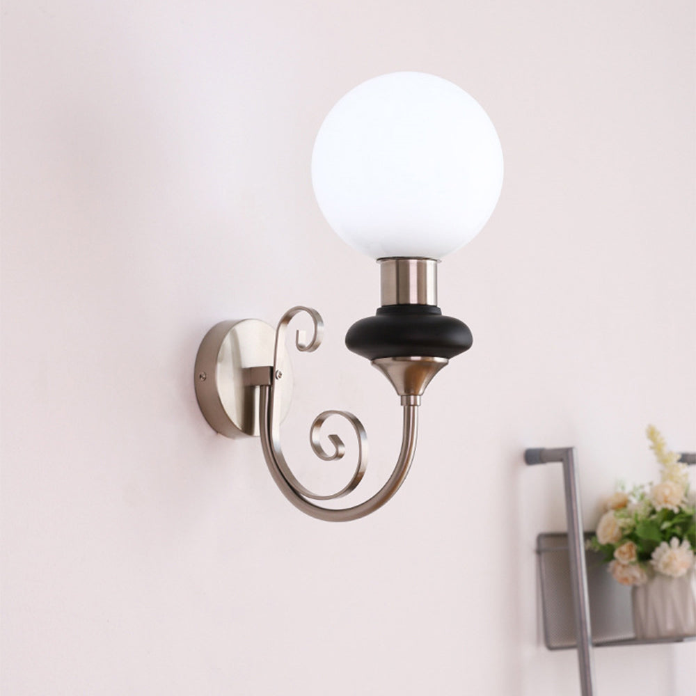 Chrome-and-black wall light with bright white globe