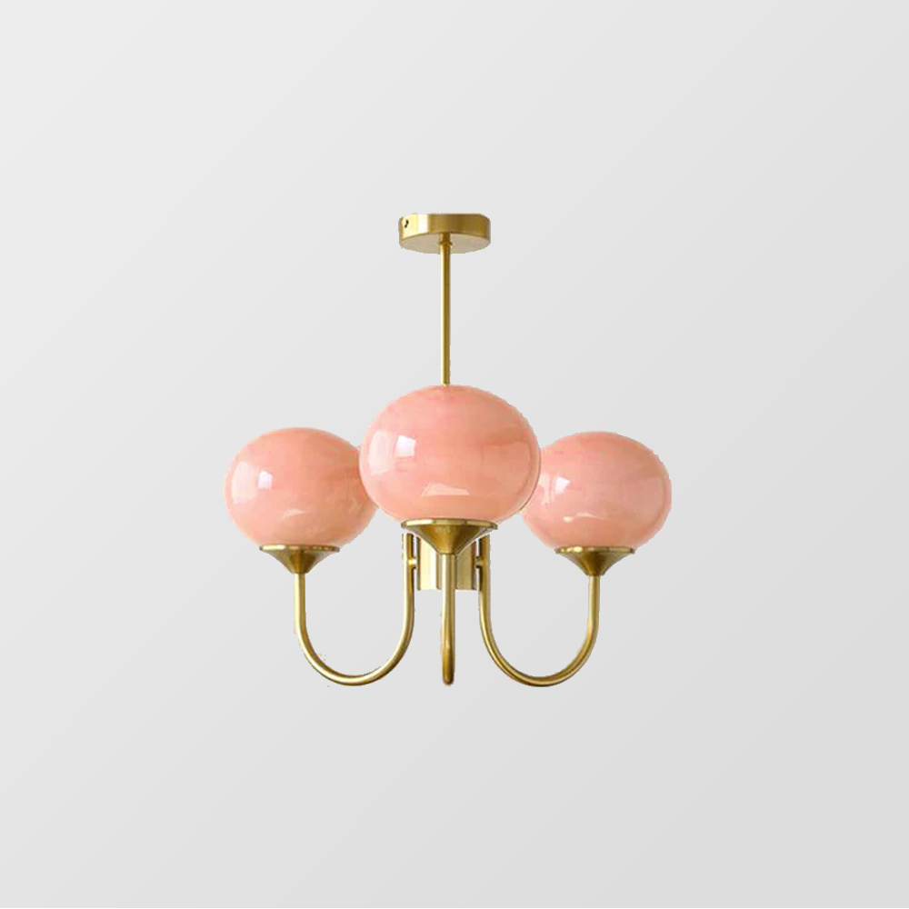 Three pink glass globe chandelier with gold-tone curved arms, a straight rod and round canopy
