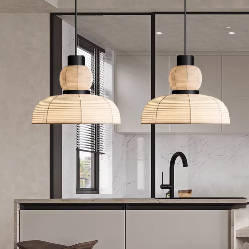 Two upper-globe and lower-dome pendants above a kitchen island and black-framed glass partition