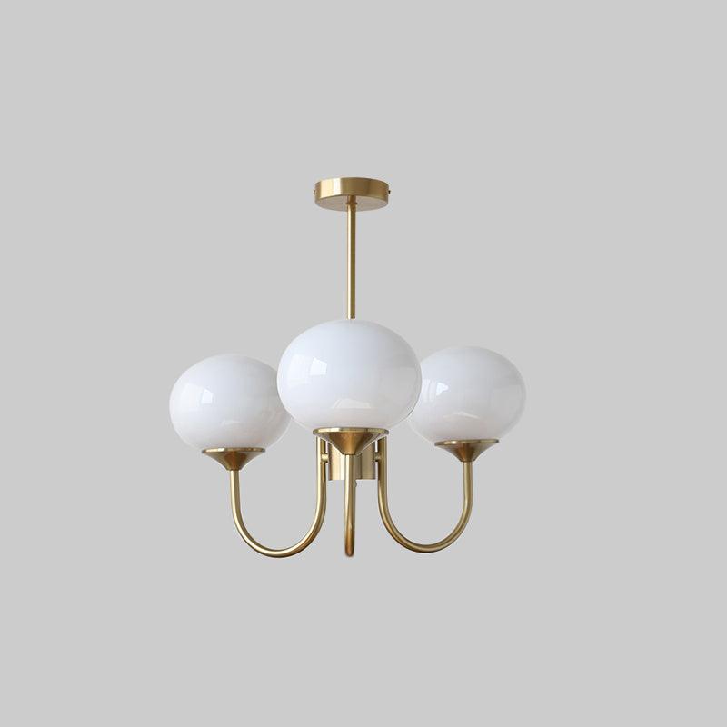 Three white glass globe chandelier with gold-tone curved arms, a straight rod and round canopy