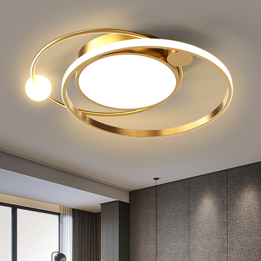 Close gold-tone orbital ceiling fixture with central disk, luminous-edged ring and small sphere