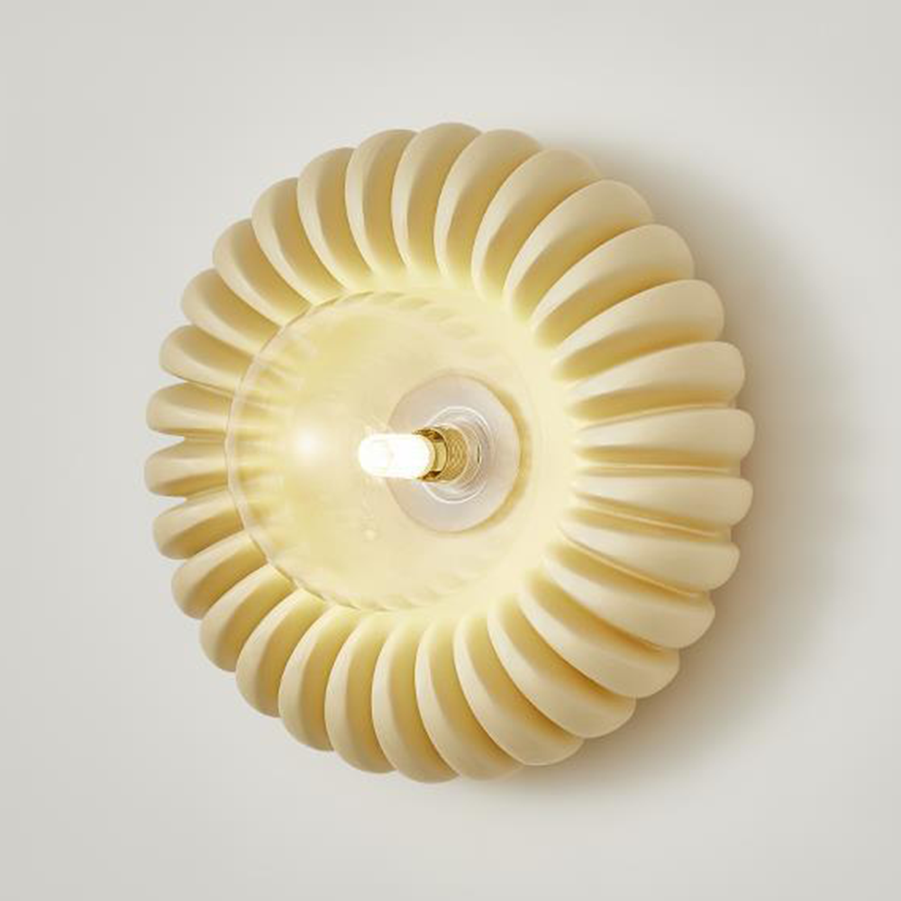 Isolated oblique beige fluted ring with Clear centre dish, lit capsule bulb and gold-tone collar