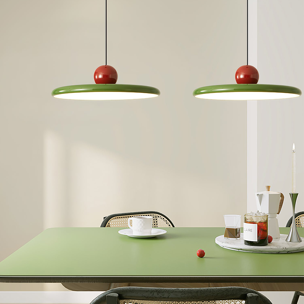 Two separate Lola green disc pendants above a table