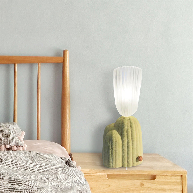 Cactus-shaped bedside light on a wooden nightstand