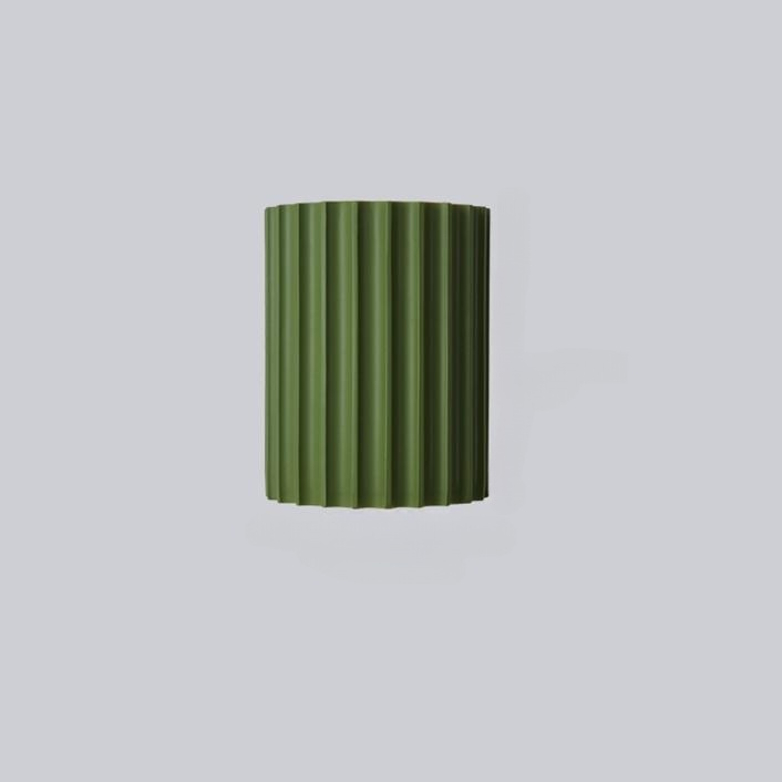 Unlit front view of a green half-round fluted wall shade on a grey background