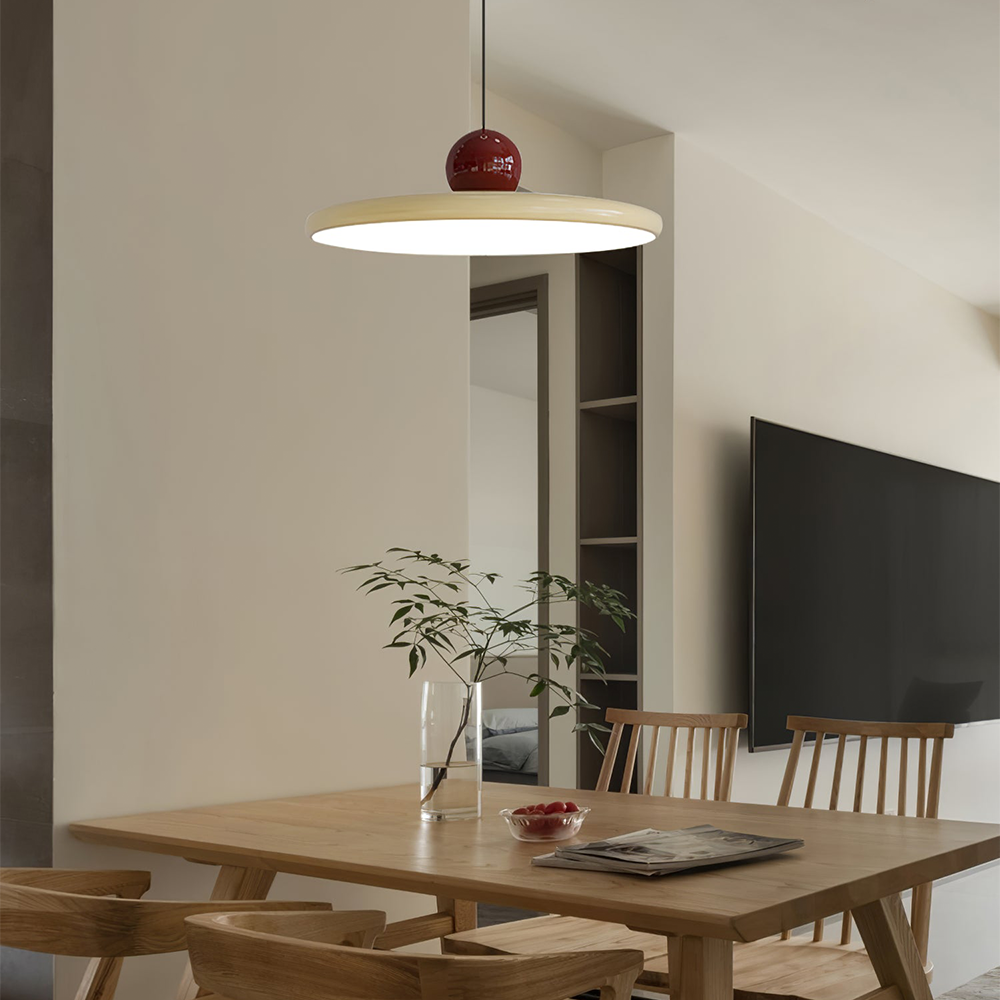 Lola beige disc pendant above a dining table beside a television