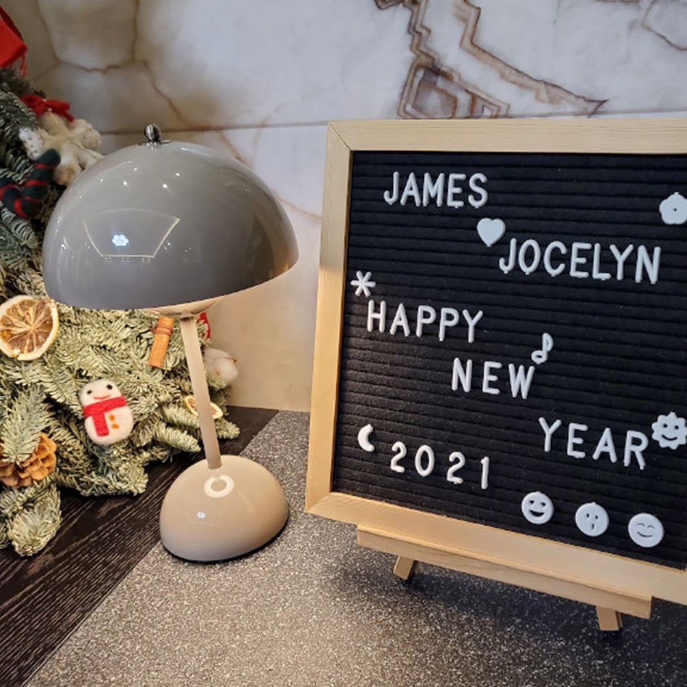 Pale grey dome lamp beside a New Year letter board and festive foliage