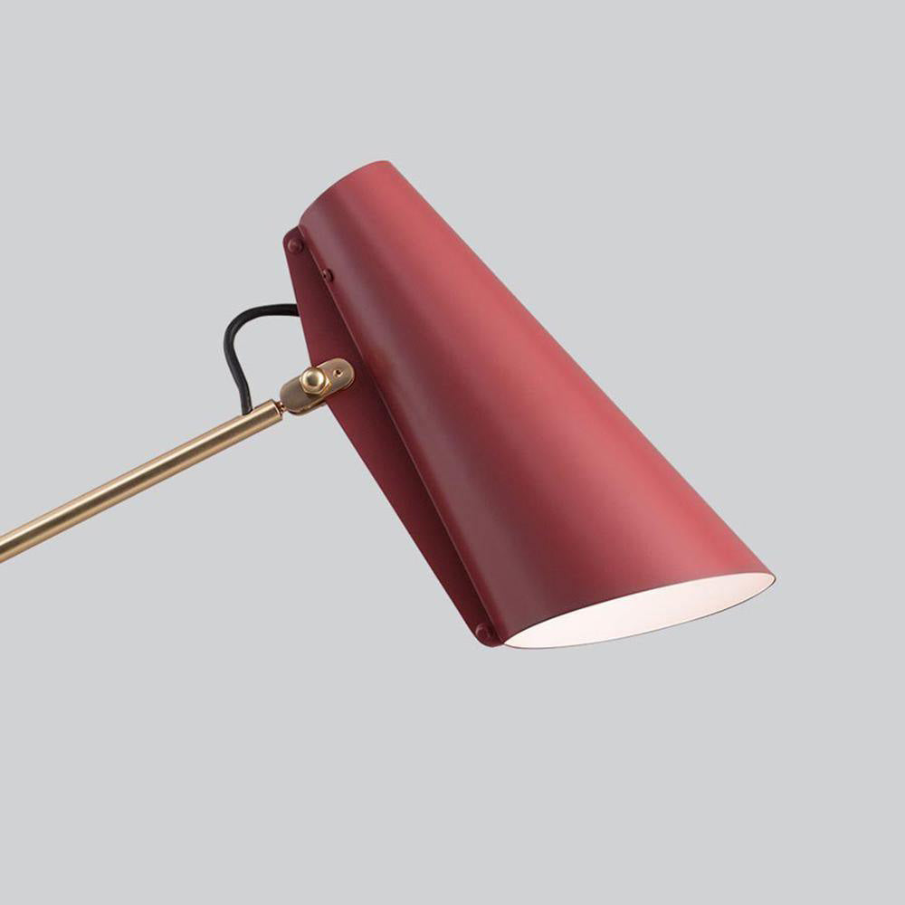 Close-up of red tapered shade showing edge fasteners, side bracket, gold-toned rod and black cable loop