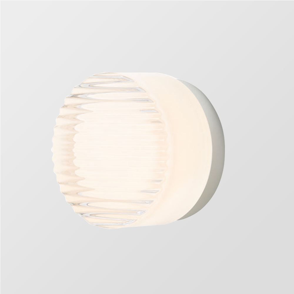 Angled white round wall fixture with horizontal ribs across the clear front, pale cylindrical body and circular plate