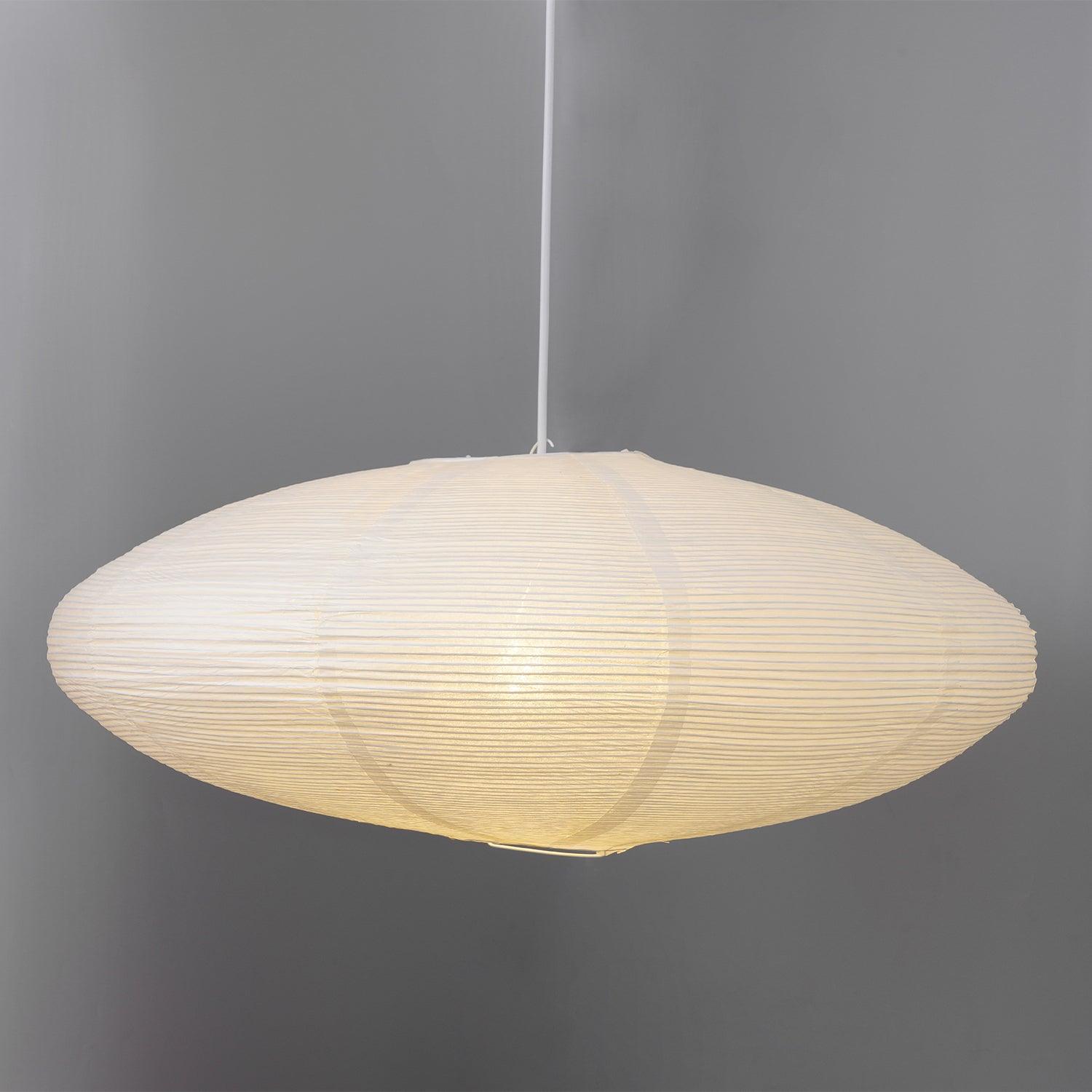 Glowing flattened paper shade on grey showing horizontal ribs and curved vertical joins
