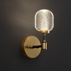 Angled view of the clear crosshatched shade, circular gold-tone plate and black right-angle arm
