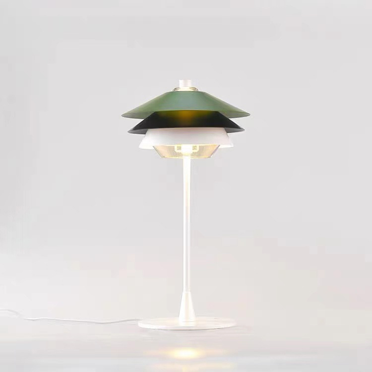 Front view of illuminated Overlay lamp with a white stem, round base and pale cord extending left