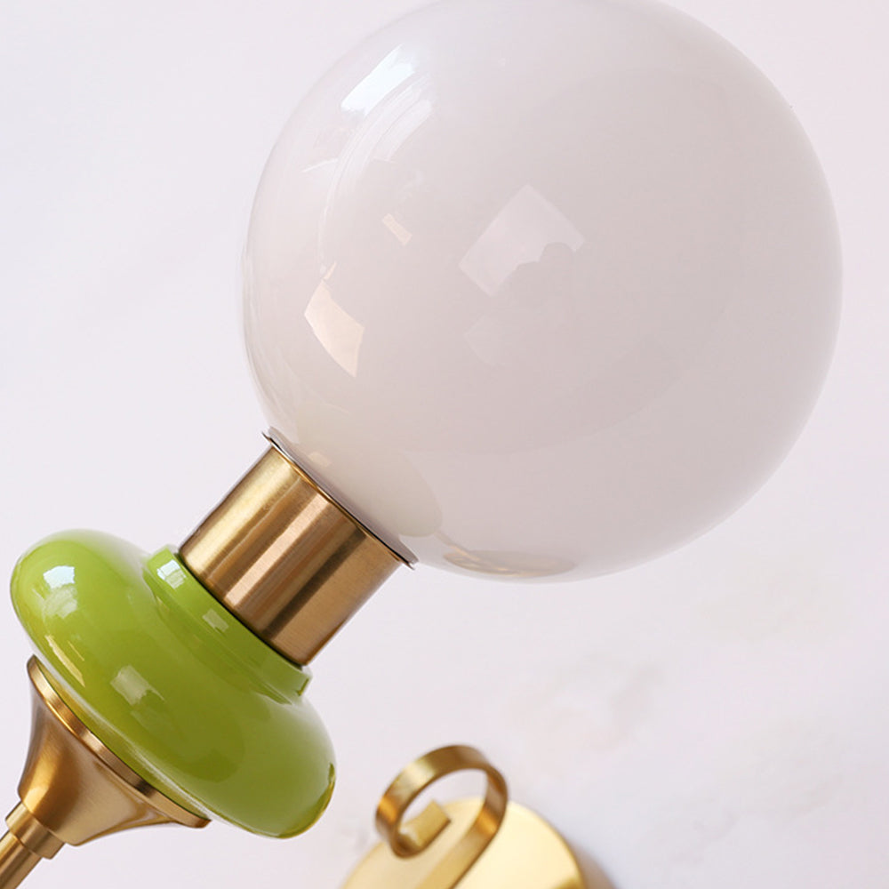 White glass globe above green collar and gold-colour fitting
