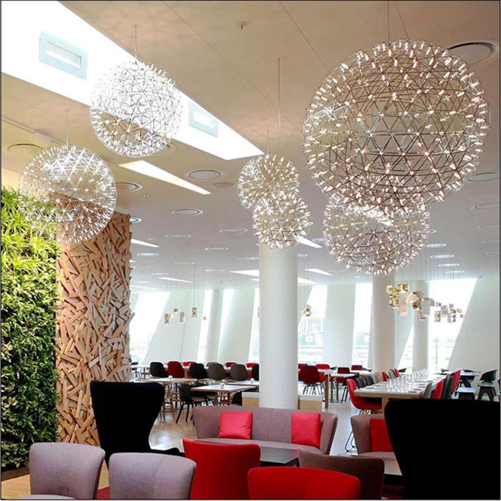 Lit open-sphere pendants in a bright restaurant with white columns and coloured seating