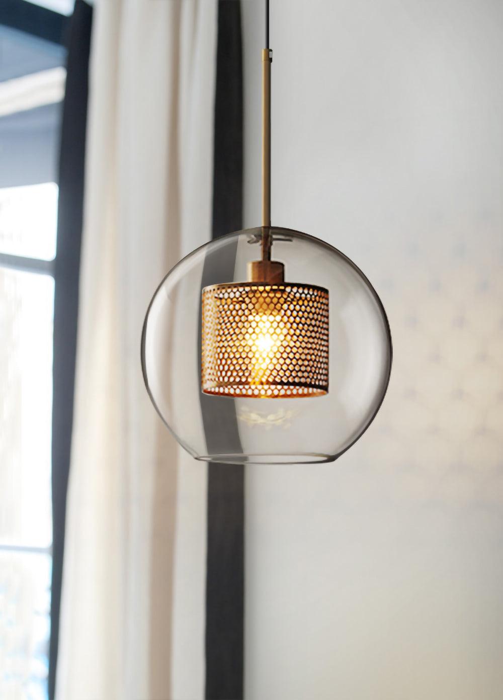 Clear globe-like shade beside a window