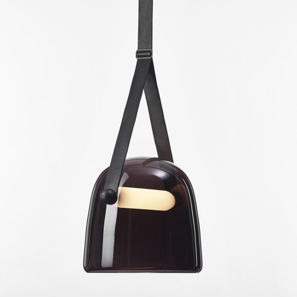 Dark smoked glass pendant with black split strap and bright horizontal bar, viewed against white