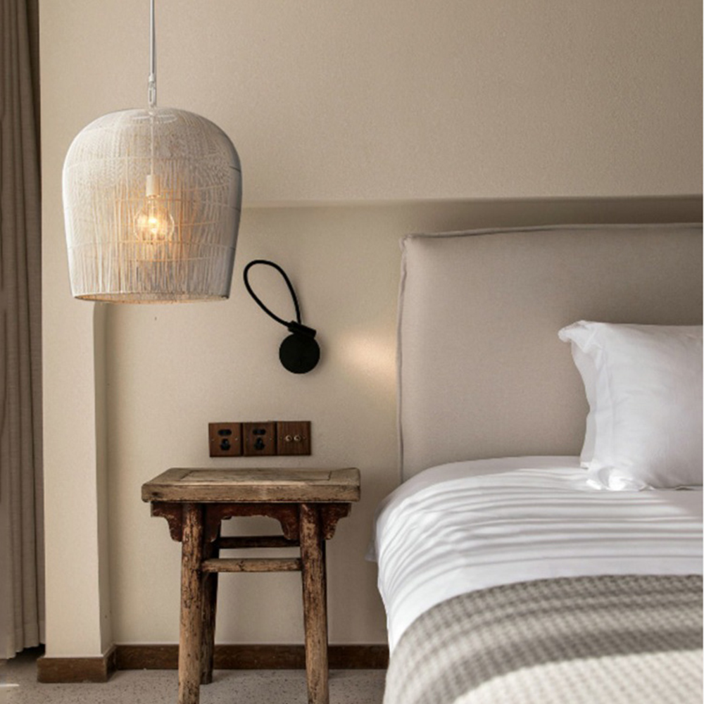 White woven pendant above a rustic bedside table