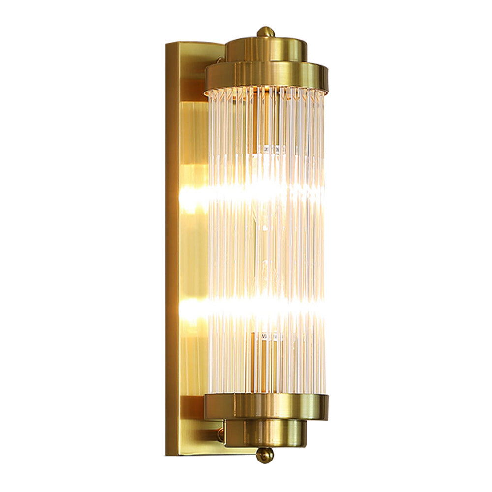 Isolated illuminated Gold wall light with clear rods, stepped circular caps, small finials and a long rectangular backplate