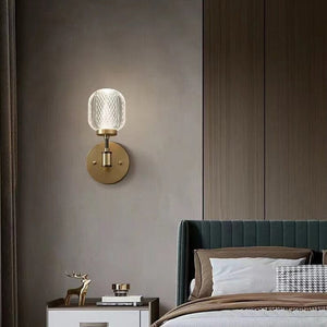 Gold wall light beside timber panelling and a teal tufted headboard above a bedside table