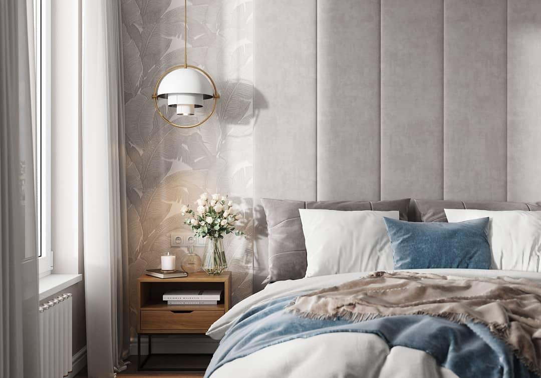 White domed ring pendant above a bedside table with flowers.