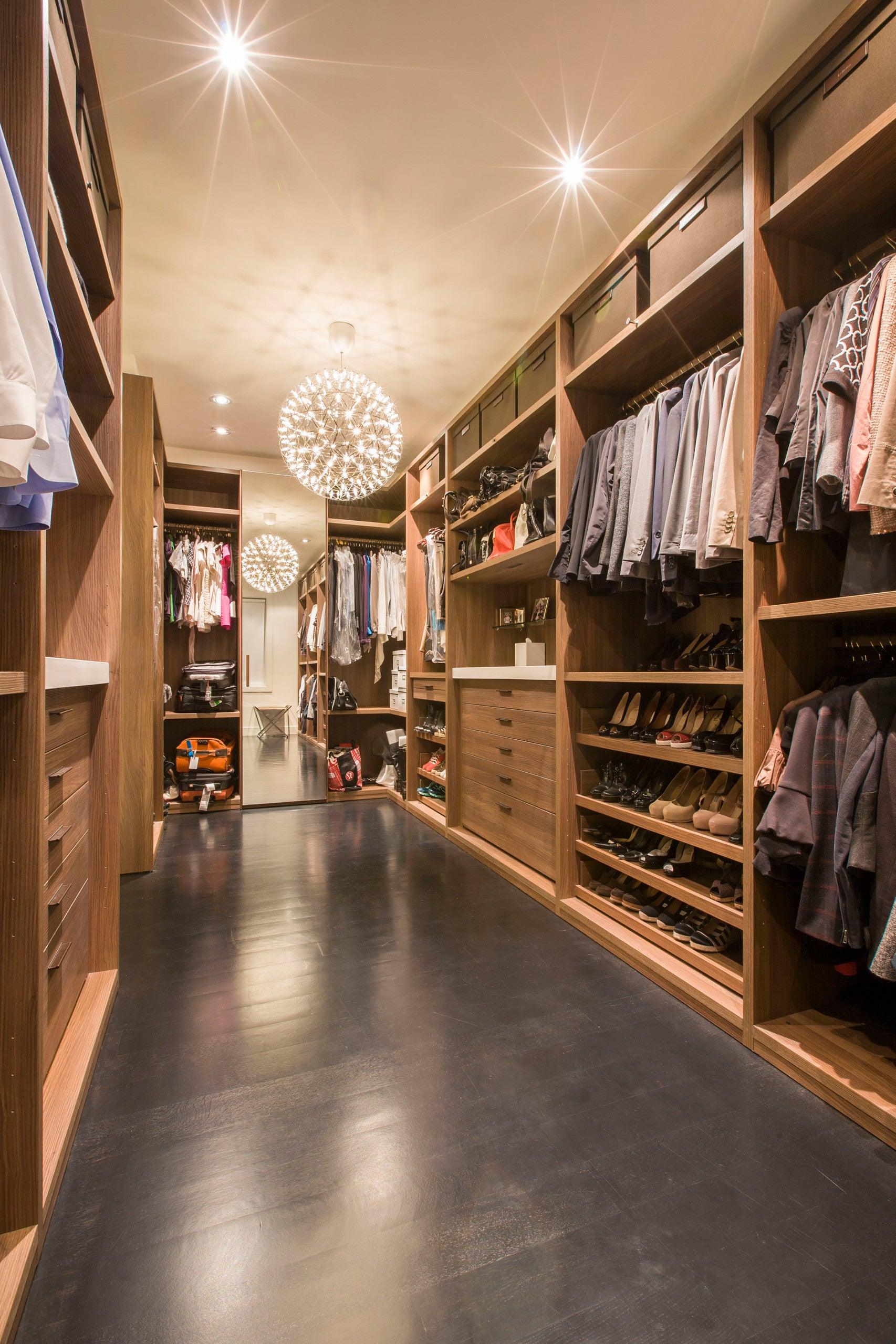 Glowing sphere in a wood-lined wardrobe with clothes, shoes, bags and a mirror
