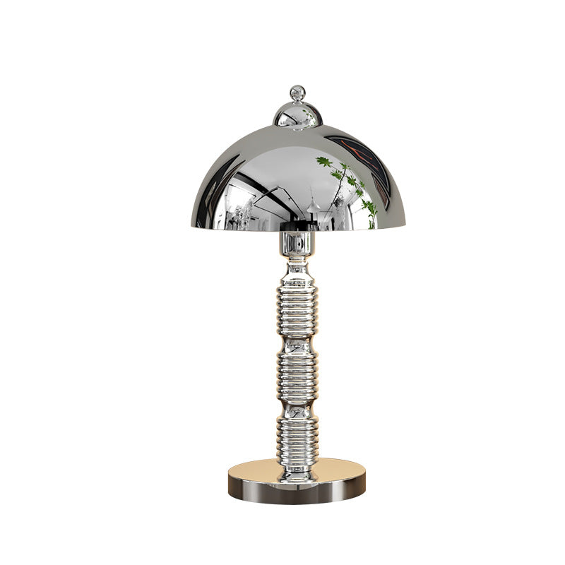 Isolated chrome table lamp with reflective dome, ball finial, grouped ribs along the stem and circular base