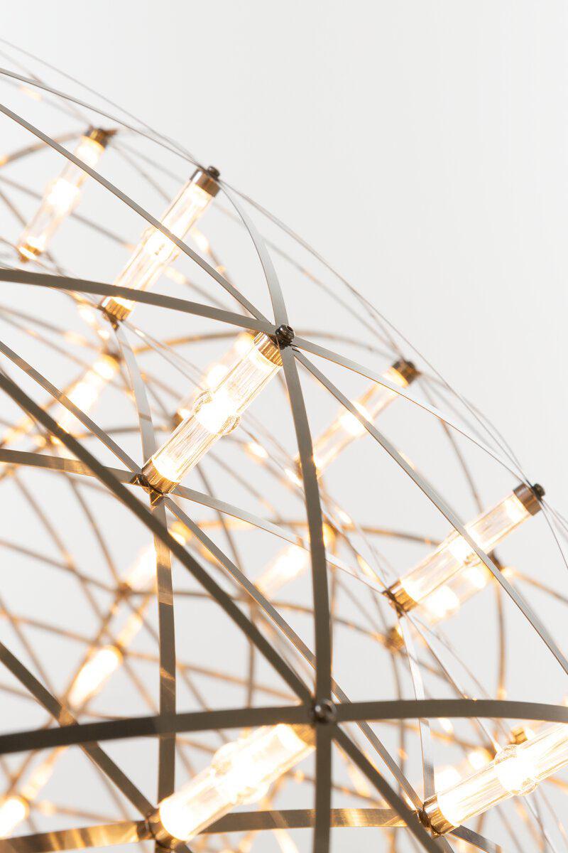 Close view of lit cylindrical LED nodes among intersecting metal strips and curved hoops