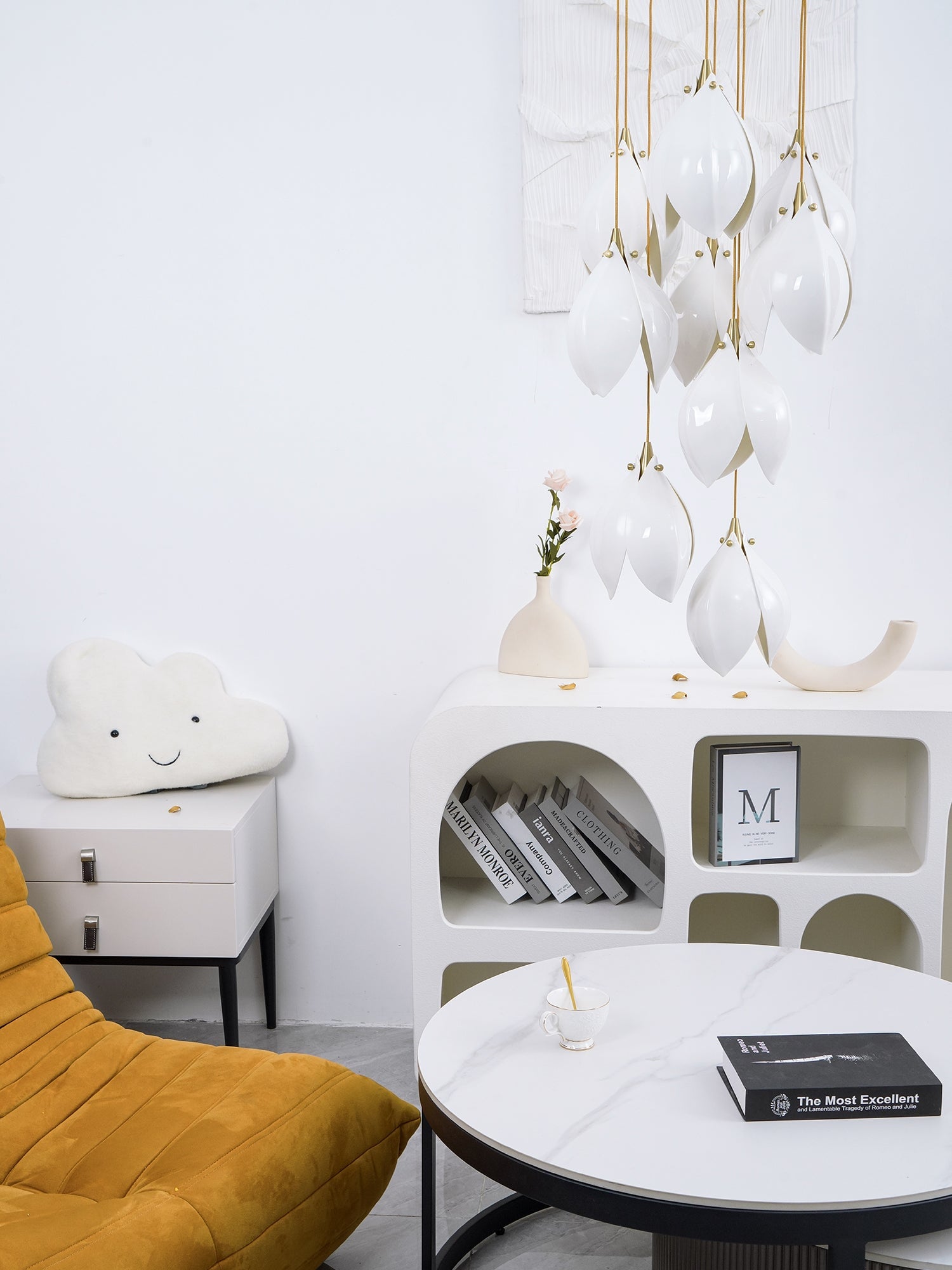 Unlit white flower buds above a pale arched console and a cloud cushion