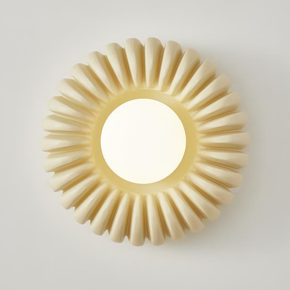 Slightly oblique lit White-centred beige wall light against a pale background