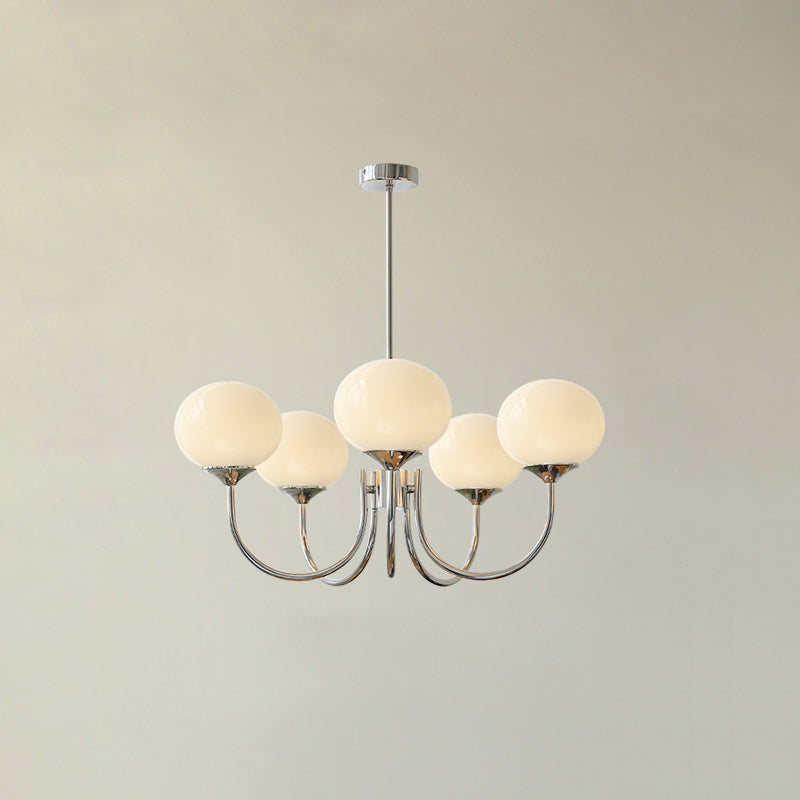 Five beige glass globes on chrome-tone curved arms beneath a round canopy