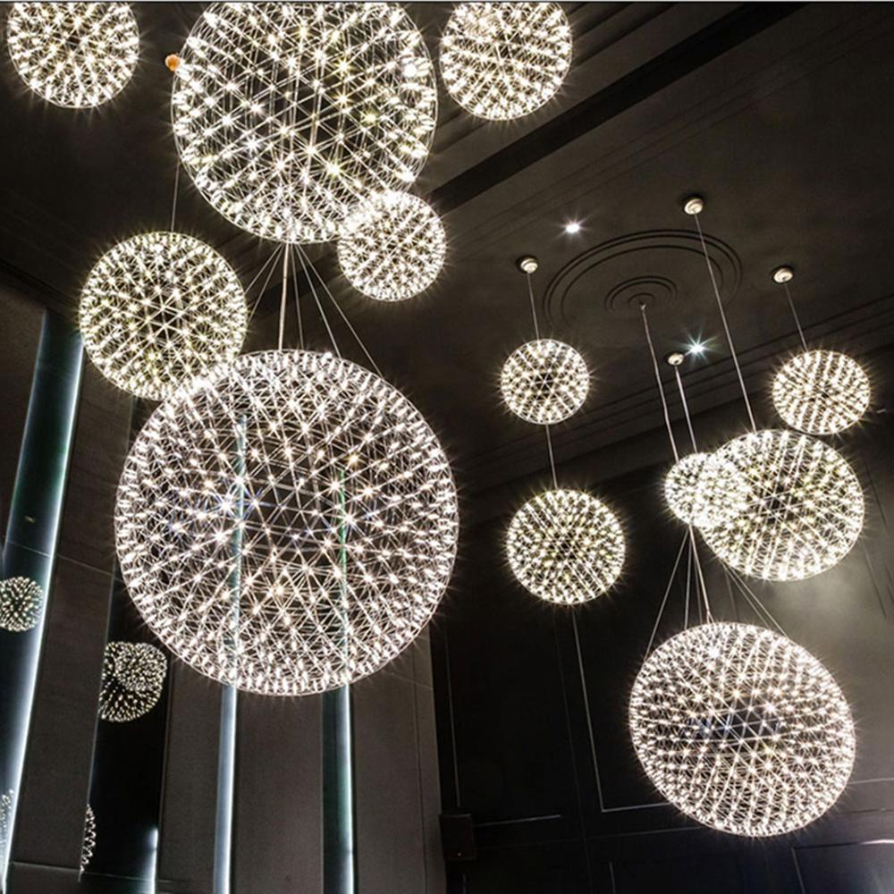Multiple lattice spheres suspended in a dark high-ceilinged space