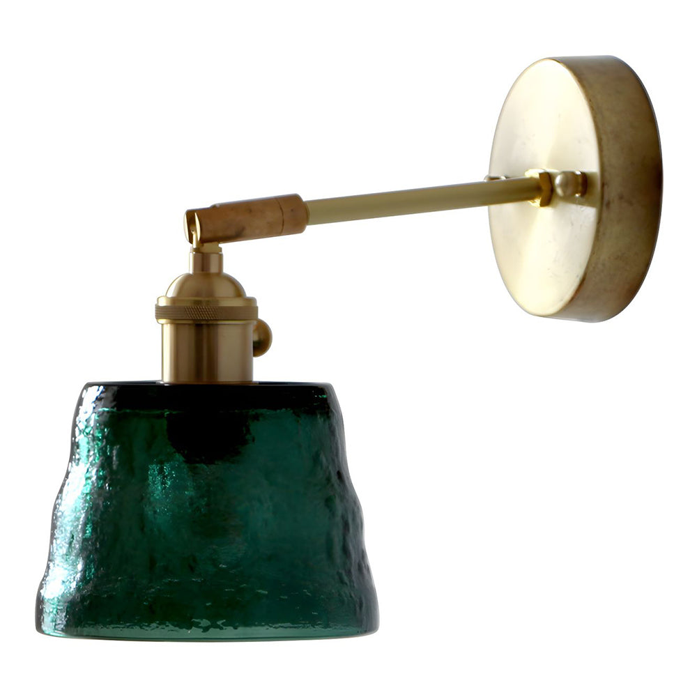 Isolated unlit green bell shade on horizontal gold-tone arm with circular wallplate and side knob