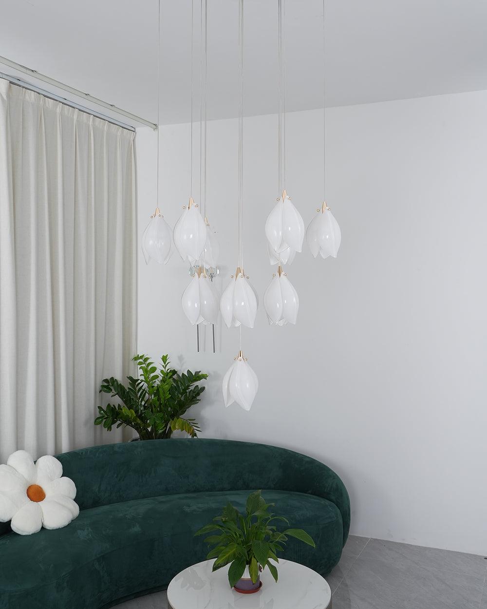White flower-bud cluster above a green sofa with a daisy cushion