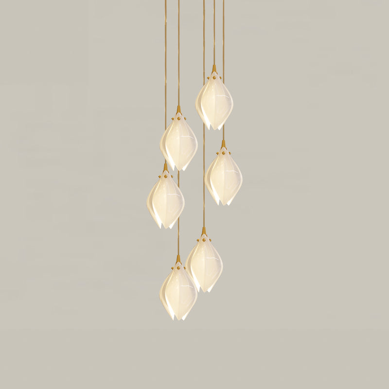 Six glowing white flower buds at staggered heights on gold-tone cords against grey