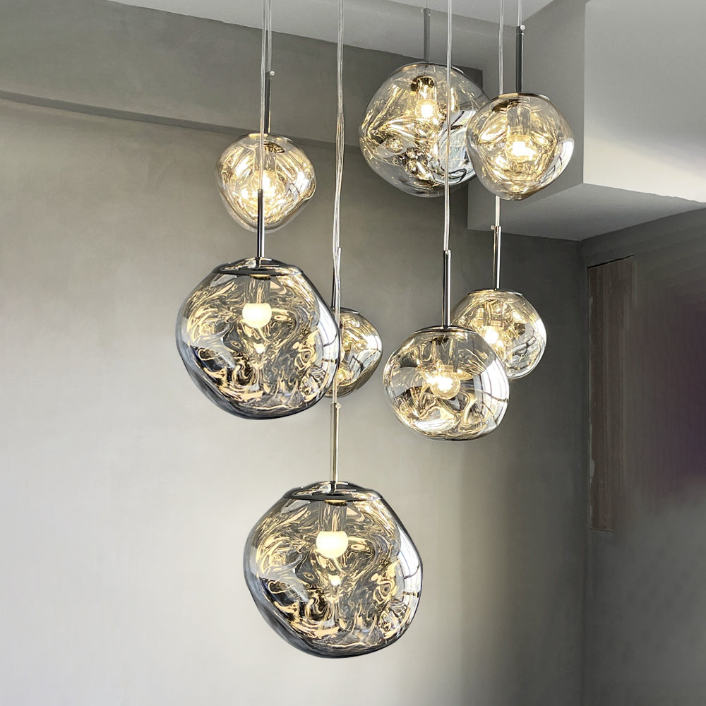 Cluster of glowing Silver irregular shades at different heights against a light grey wall