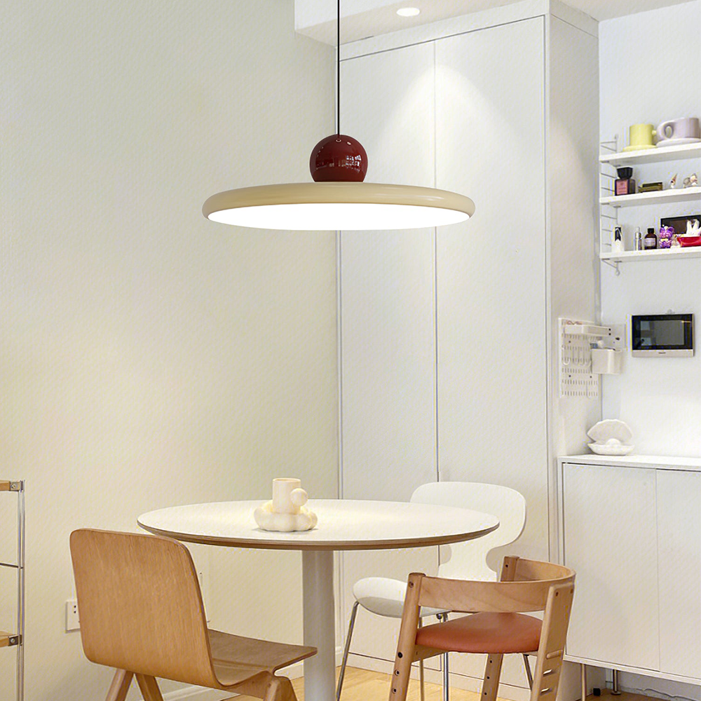 Lola beige disc pendant above a small round dining table