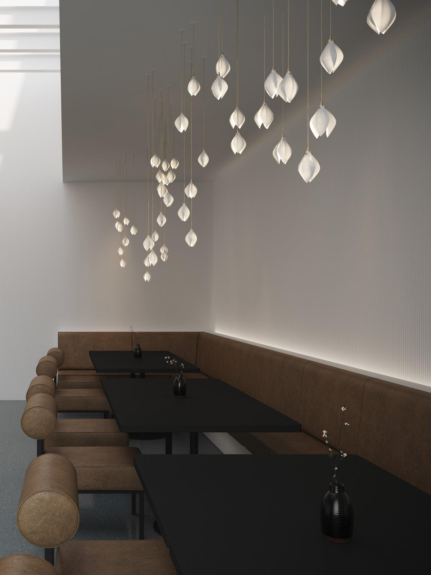 Individually mounted flower pendants above restaurant tables and brown seating