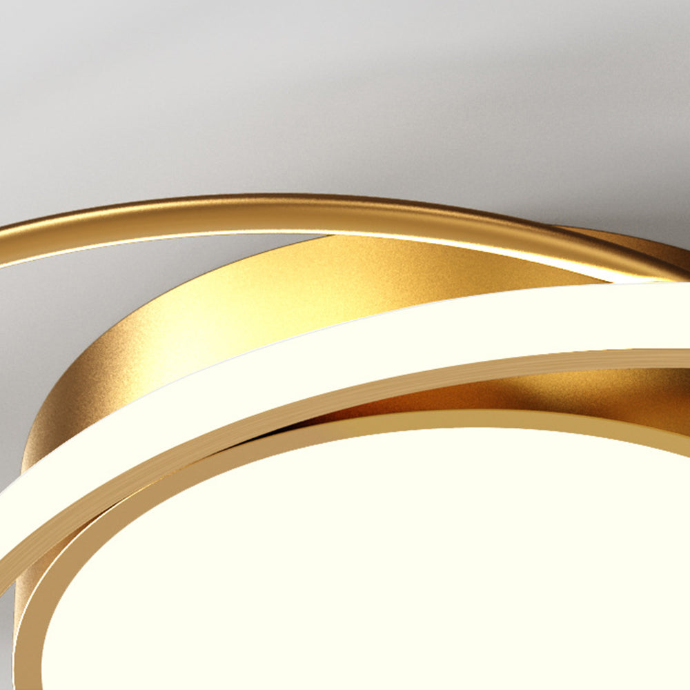 Close gold-tone ceiling housing and curved luminous ring above the central diffuser