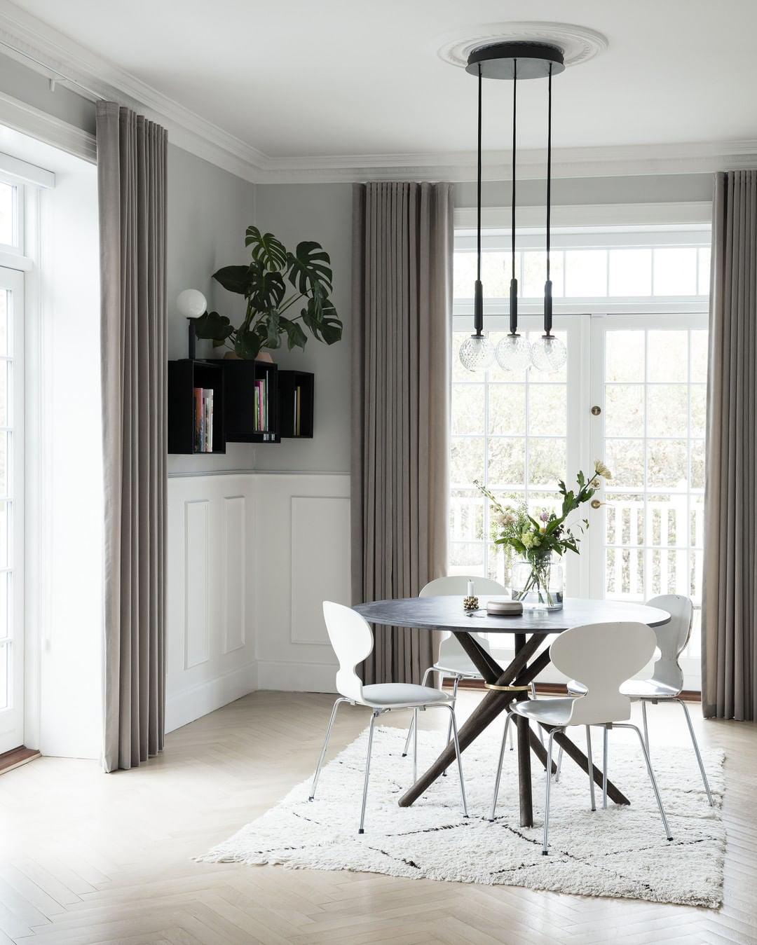 Long-stem globe lighting over a dining table